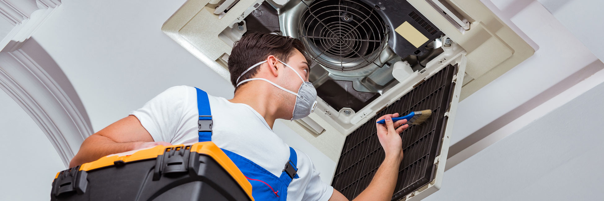Technician Repairing Ceiling Air Conditioning